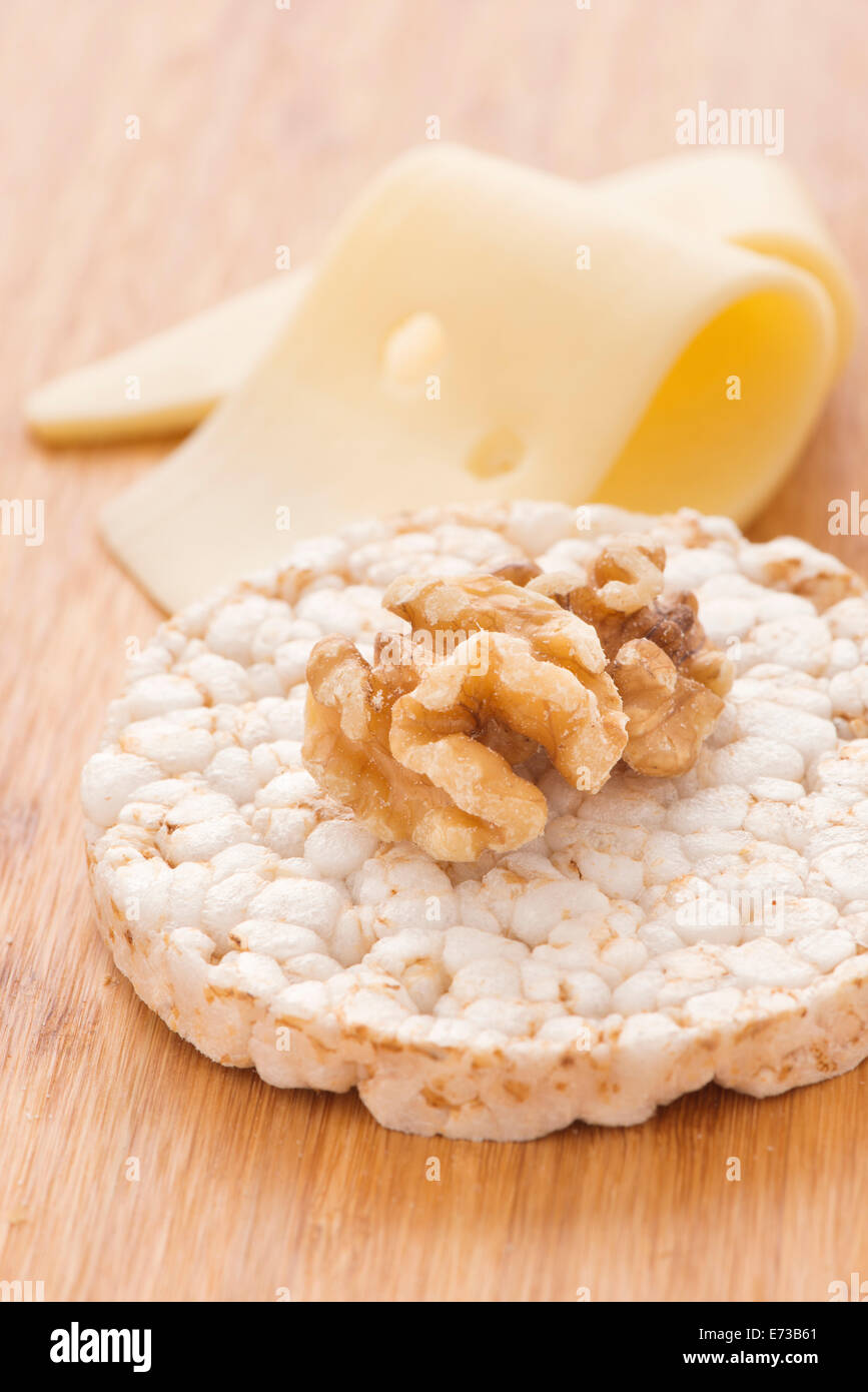 Rice cake and walnut with sliced cheese in the background. Healthy lifestyle food. Stock Photo