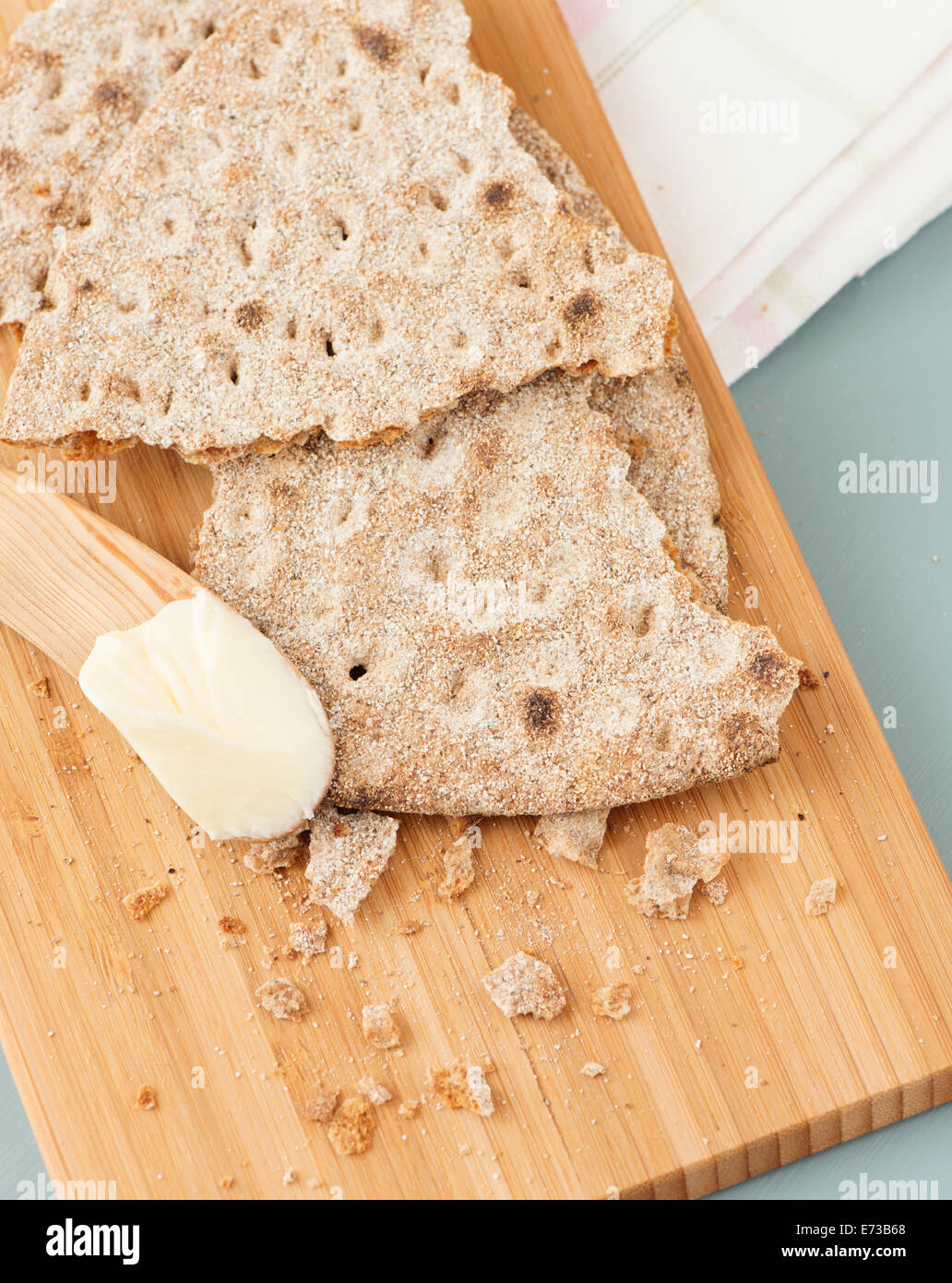 Closeup of swedish crispbread, flat rye bread, on wooden cutting board. Stock Photo