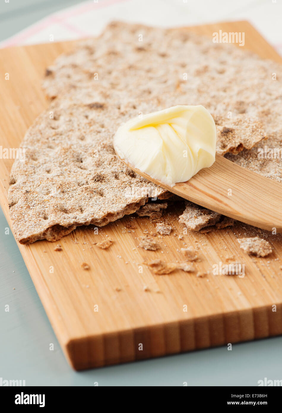 Closeup of swedish crispbread, flat rye bread, on wooden cutting board. Stock Photo