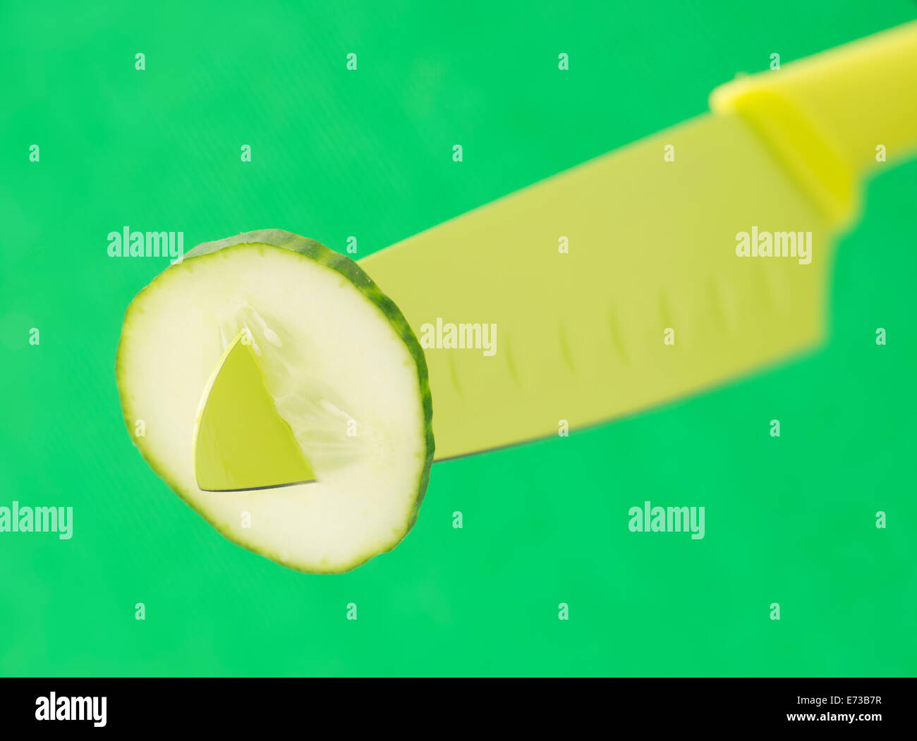 Cucumber slice and green knife Stock Photo