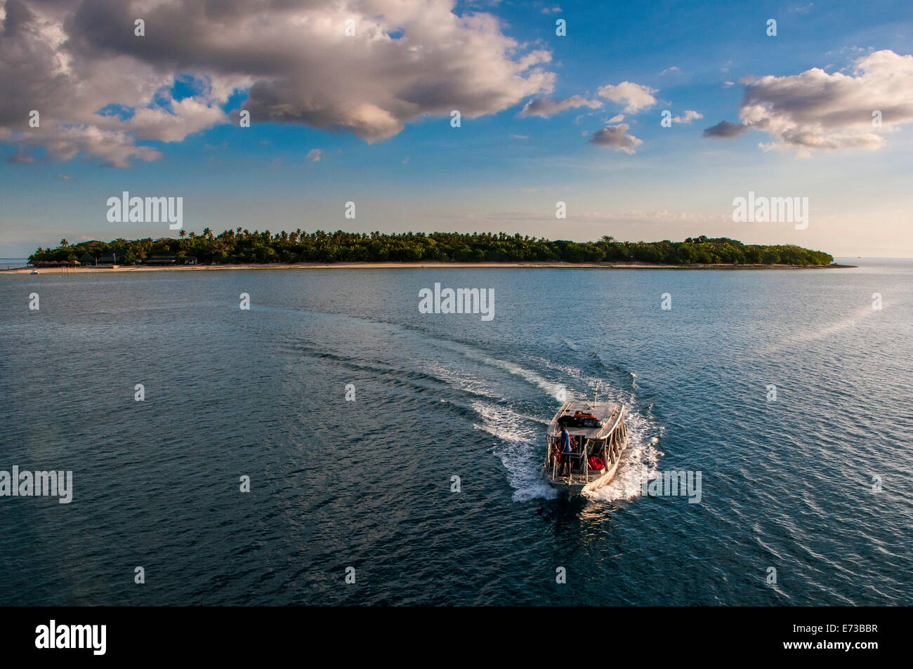 Little boat with an island beyond, Mamanucas Islands, Fiji, South Pacific, Pacific Stock Photo