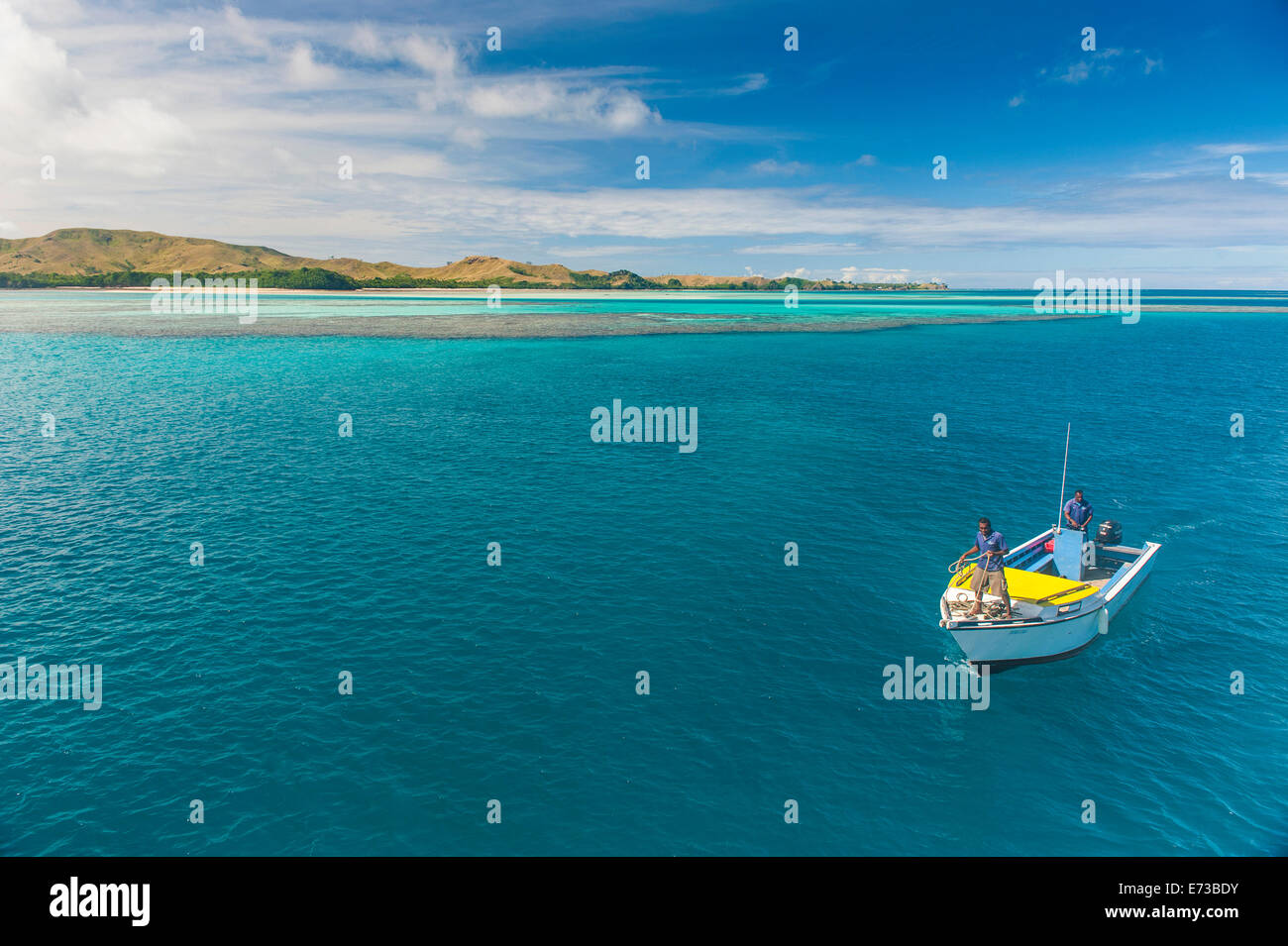 Little boat in the blue lagoon, Yasawas, Fiji, South Pacific, Pacific Stock Photo