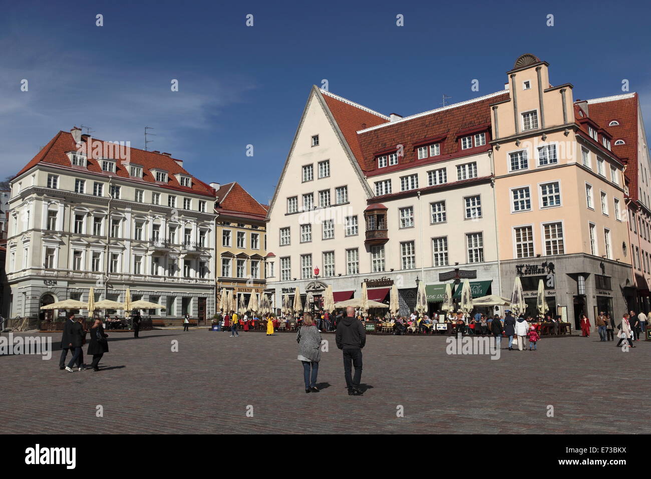 Town Hall Square, surrounded by grand, historic buildings, many now used as bars and cafes, in Tallinn, Estonia, Europe Stock Photo