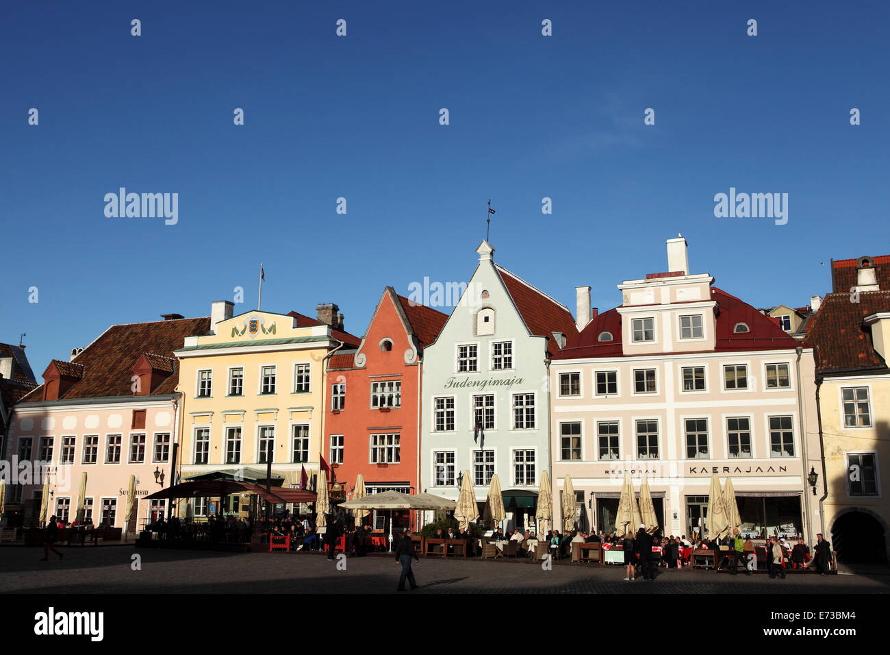 Town Hall Square, surrounded by grand, historic buildings, many now used as bars and cafes, in Tallinn, Estonia, Europe Stock Photo
