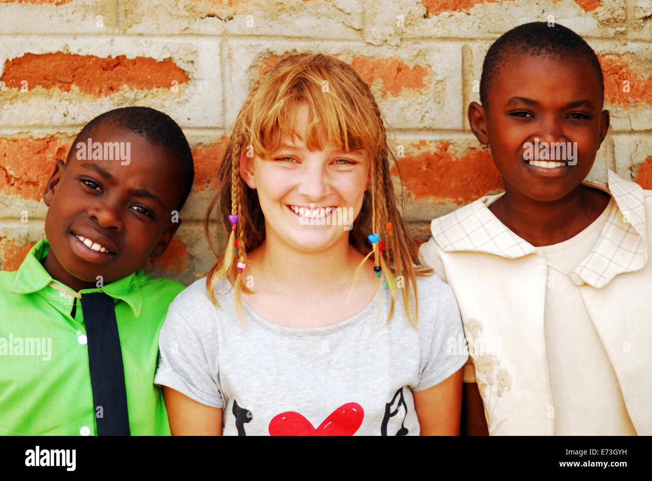 Kenya, Kakamega, black and white schoolgirls posing for camera (MR). Stock ...