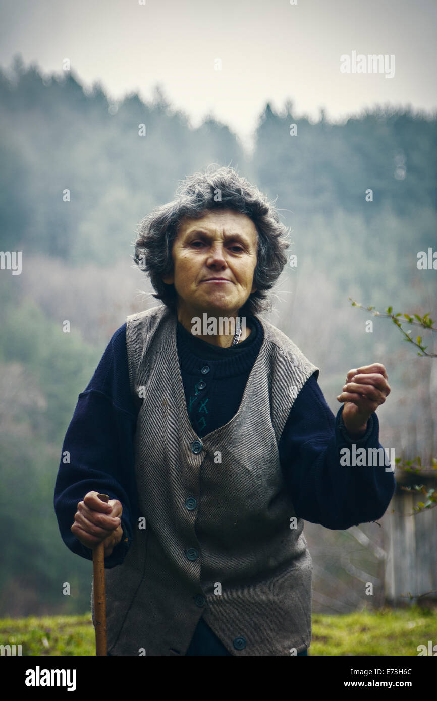 Old village lady from Serbia explains moment from her life Stock Photo