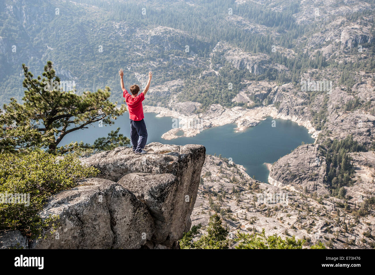 A boy excited to look from above the Donnell Lake, along the Sonora road, California. Stock Photo