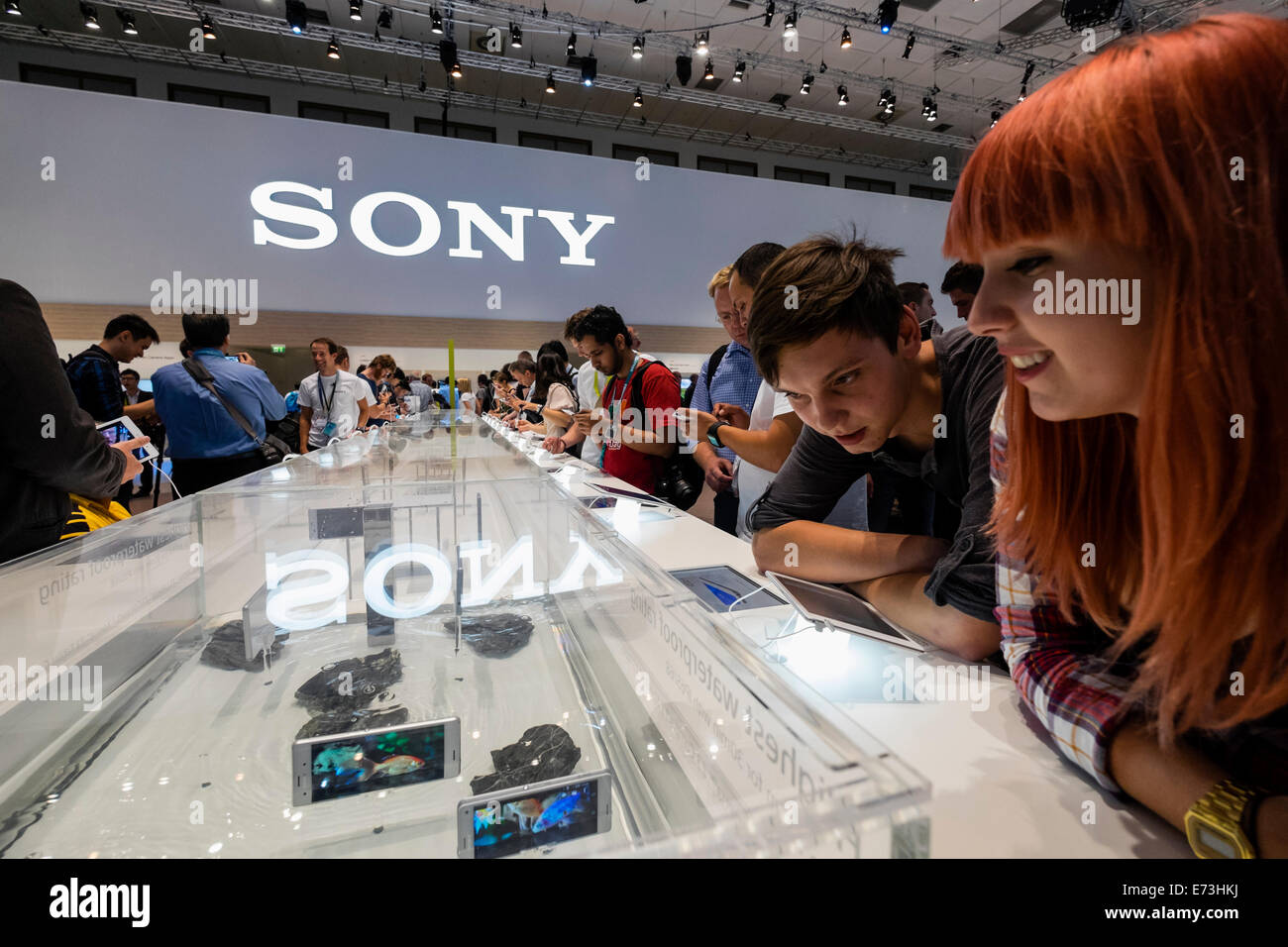 Berlin, Germany. 5th September, 2014. Visitors to Sony stand examine waterproof Xperia tablets and smart phones in water tank at IFA 2014 consumer electrical show in Berlin Credit:  Iain Masterton/Alamy Live News Stock Photo