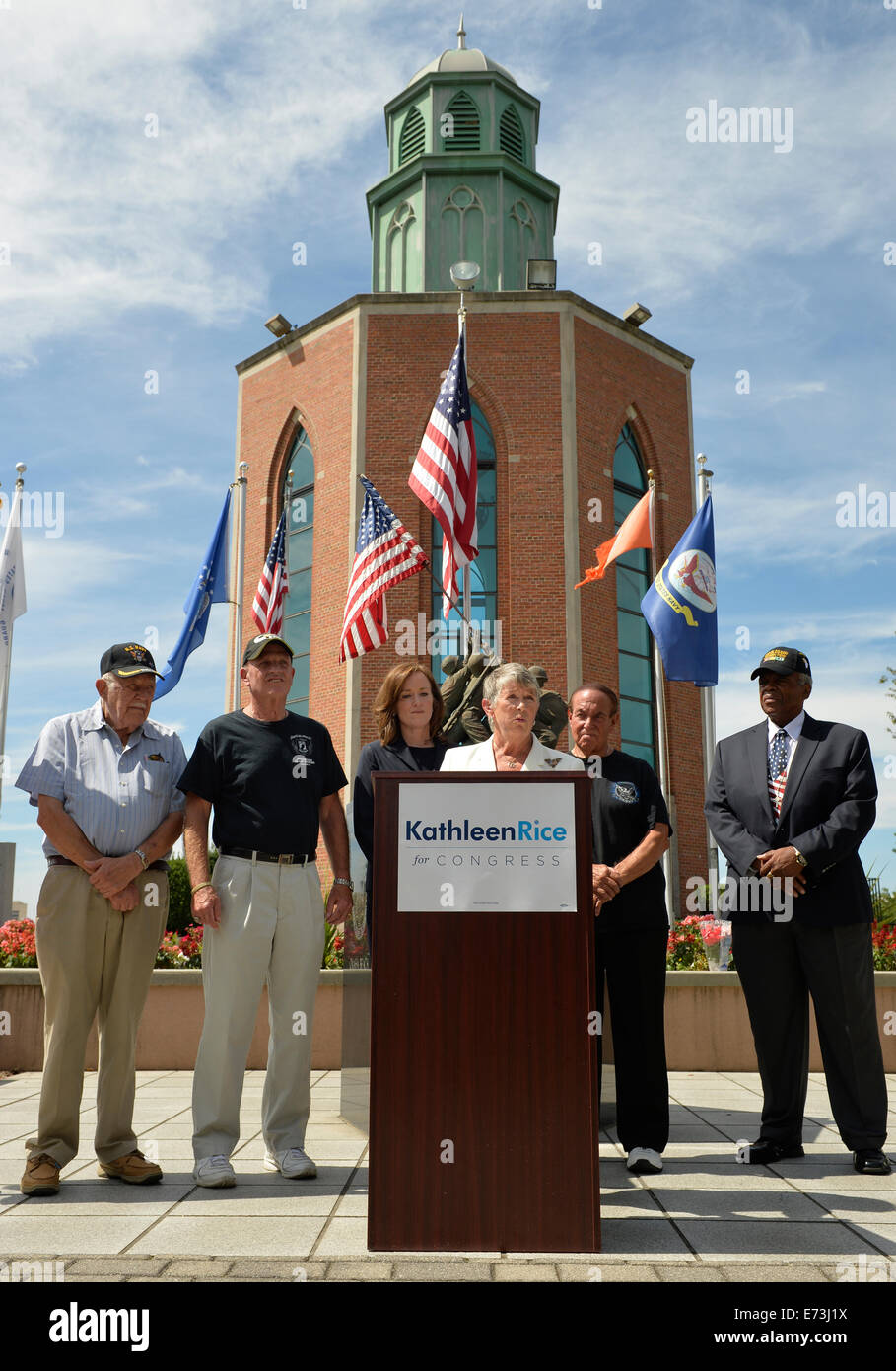 East Meadow, New York, USA. 3rd September, 2014.  Representative CAROLYN MCCARTHY is speaking at podium during press conference when KATHLEEN RICE, (in black jacket dress) Democratic congressional candidate (NY-04), releases a whitepaper on veterans policy and announces formation of her campaign's Veterans Advisory Committee, at Veterans Memorial at Eisenhower Park, after touring Northport VA Medical Center with McCarthy. Congresswoman McCarthy and 4 committee members joined Rice for announcement: PAUL ZYDOR, (in blue shirt) of Merrick, U.S. Credit:  Ann E Parry/Alamy Live News Stock Photo