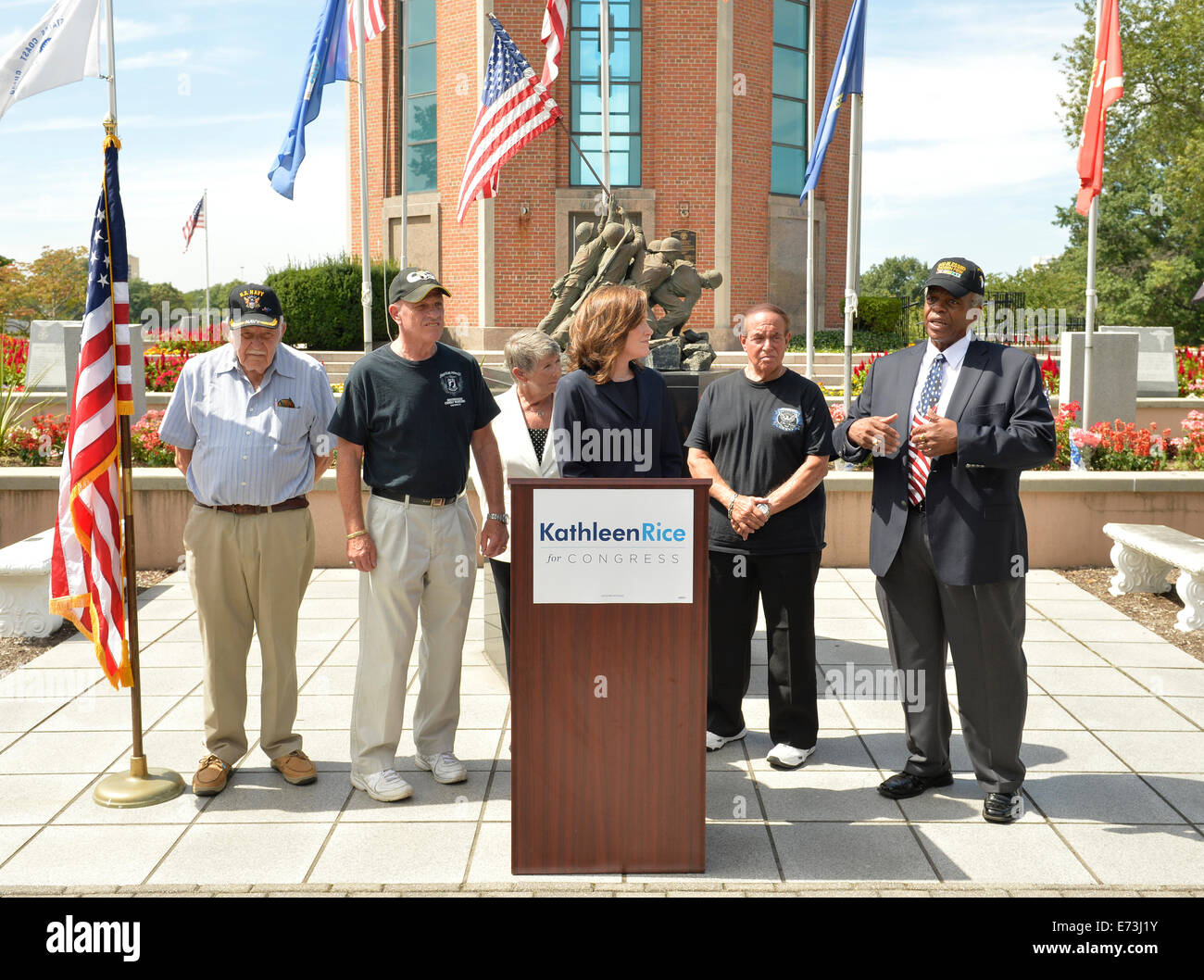 East Meadow, New York, USA. 3rd September, 2014.  KATHLEEN RICE, at podium, Democratic congressional candidate (NY-04), announces formation of her campaign's Veterans Advisory Committee, at Veterans Memorial at Eisenhower Park. Congresswoman CAROLYN MCCARTHY (in white jacket) and 4 committee members joined Rice at press conference: speaking is JEREMIAH E. BRYANT, of Rockville Centre, U.S. Army, Vietnam War Veteran; & veterans STEVE BONOM, of Massapequa, U.S. Navy, Vietnam War; PAT YNGSTROM, Merrick, US Army Vietnam War, & PAUL ZYDOR, Merrick, US Navy, Korean War.  Credit:  Ann E Parry/Alamy Li Stock Photo