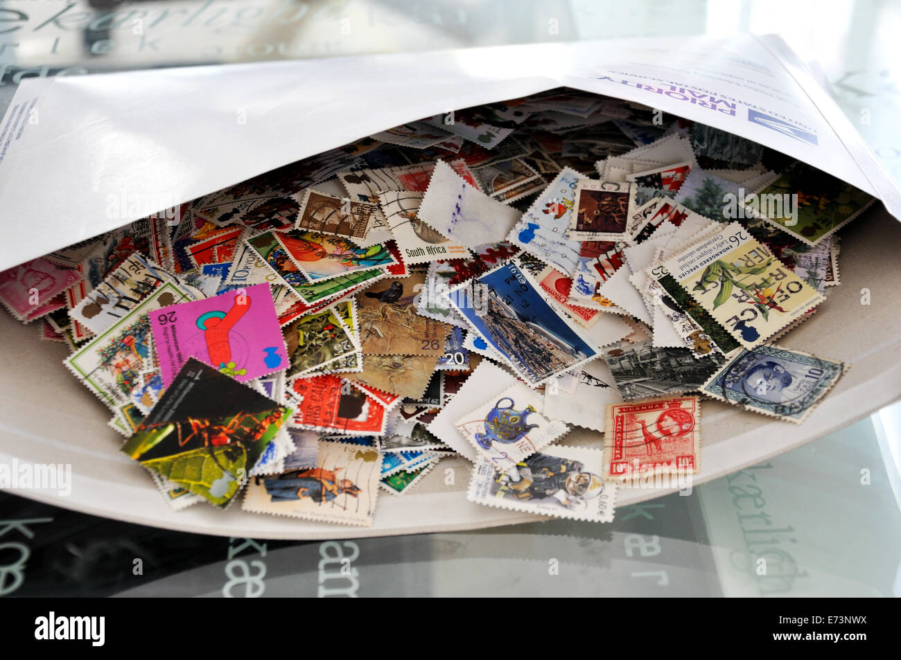 Envelope full of used postage stamps Stock Photo Alamy
