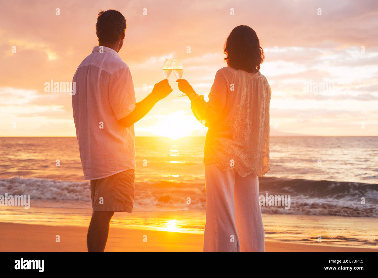 Happy Romantic Couple Enjoying Glass Of Champagne At Sunset On The