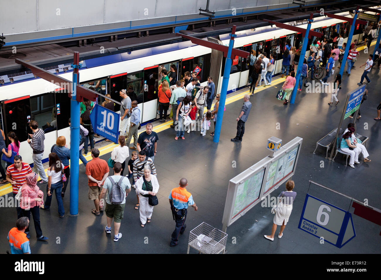 Spain, Madrid, Principe Pio Metro Station, people on platform by train. Stock Photo