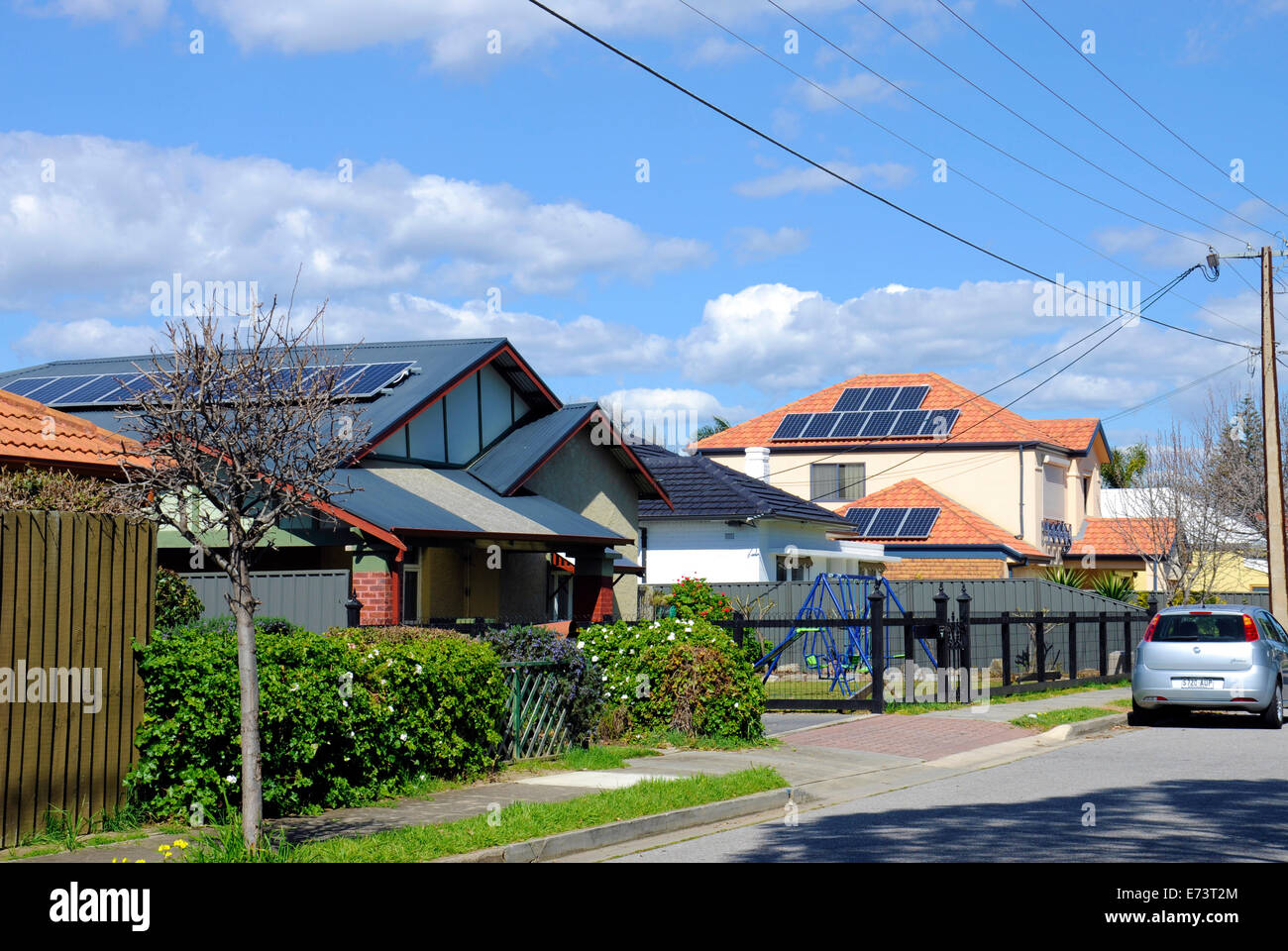 Australian photovoltaic solar power panels  on suburban street house roofs. Stock Photo