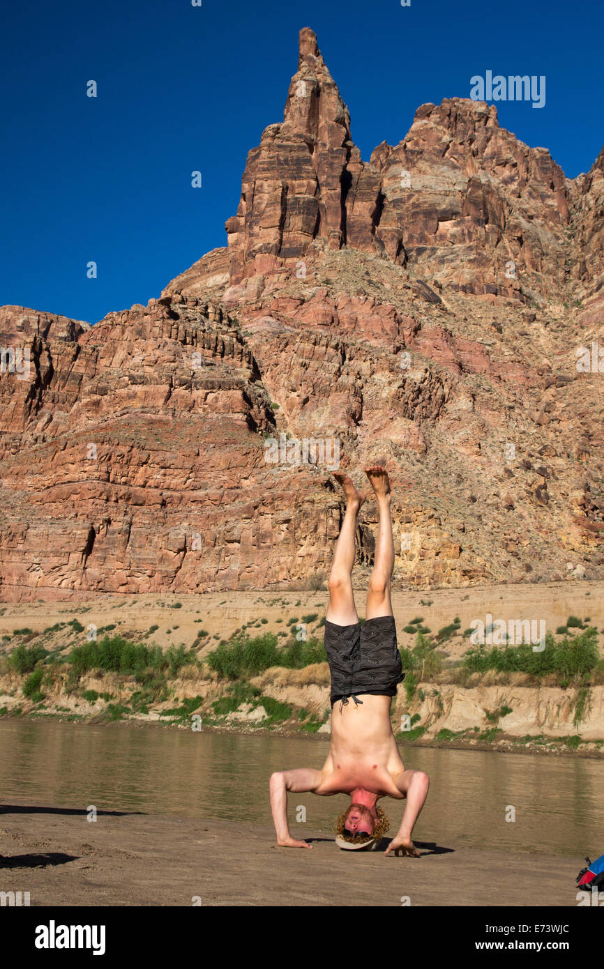 Canyonlands National Park, Utah - River guide Julian Springer practices yoga during a raft trip on the Colorado River Stock Photo