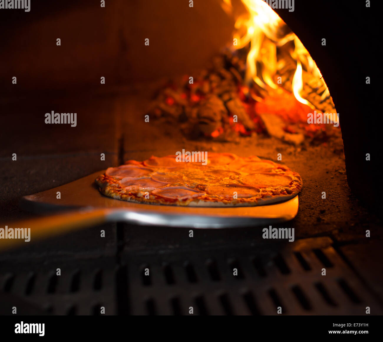 Ready pizza getting from oven Stock Photo