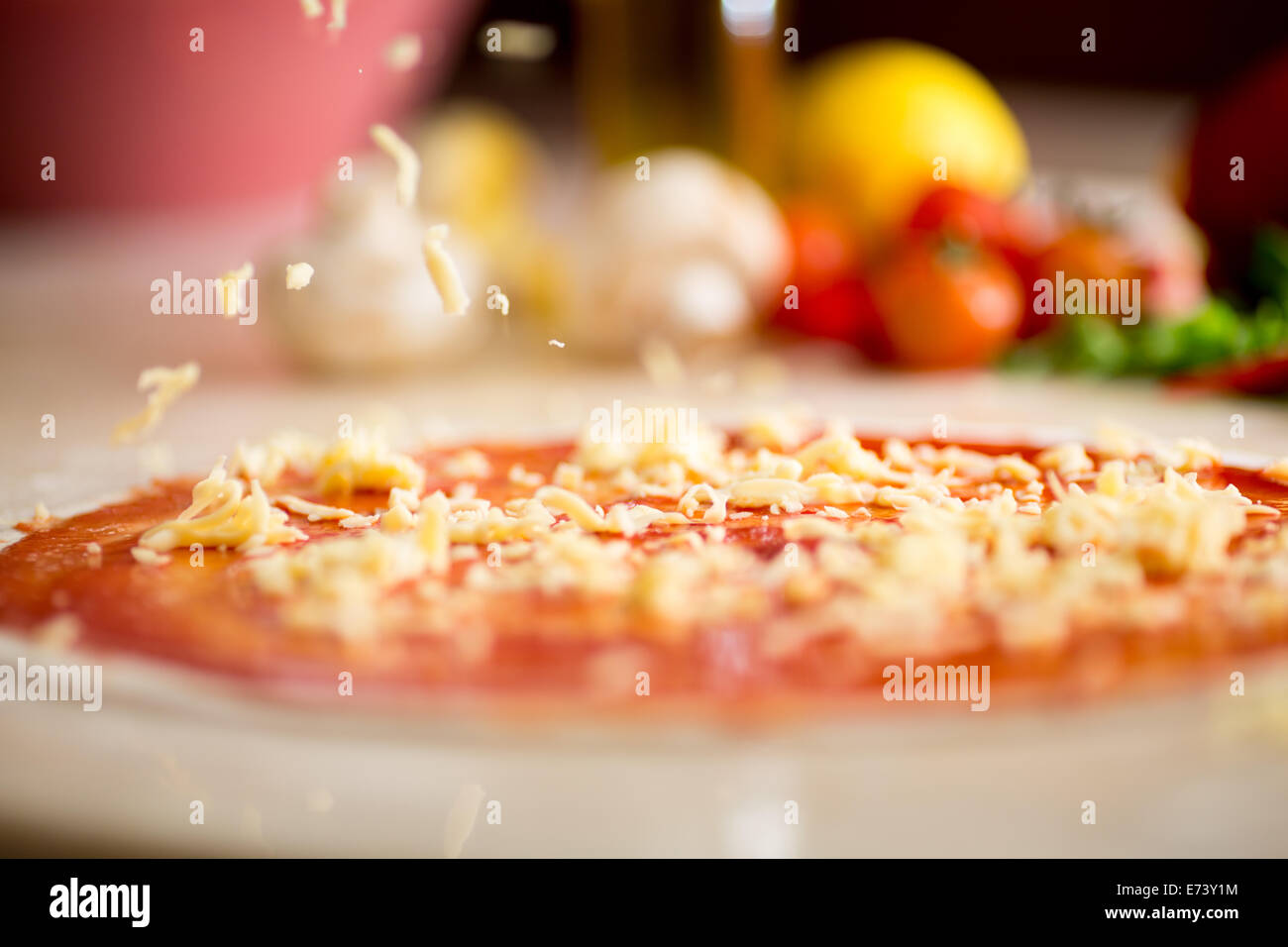 Italian pizza making with falling cheese Stock Photo