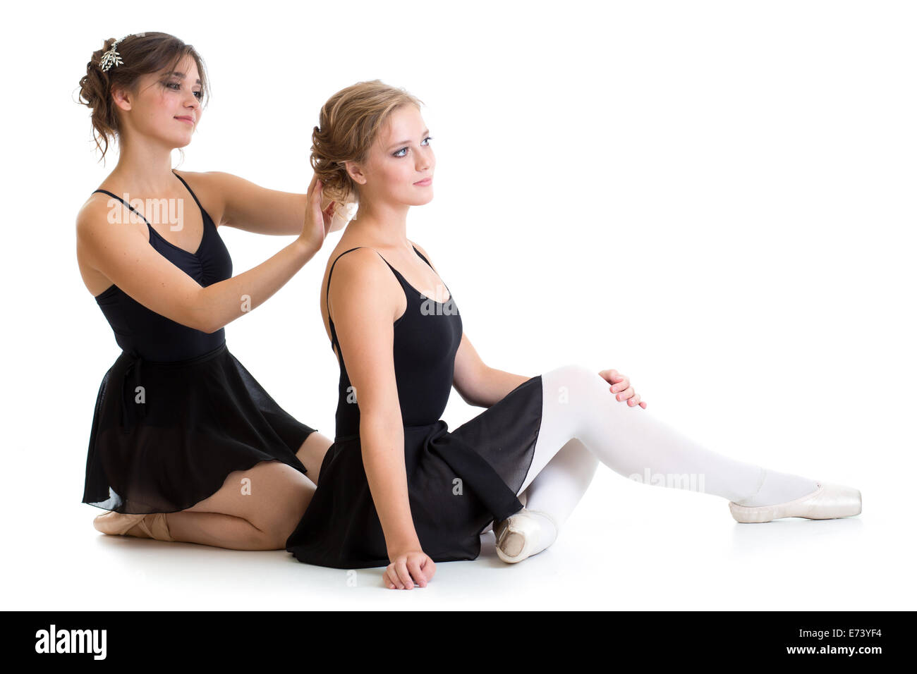 Two beautiful young dancers preparing for training together isolated Stock Photo