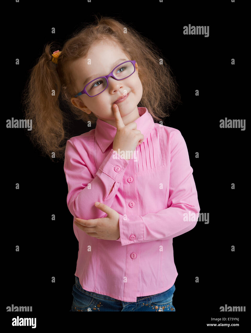 Adorable child girl in eyeglasses isolated on black Stock Photo