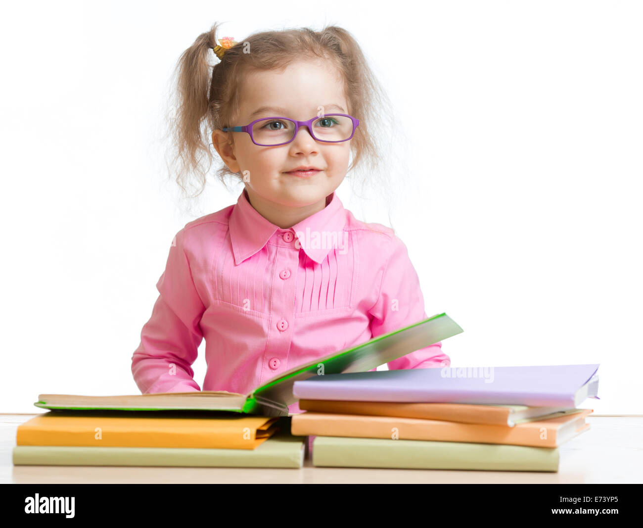 child girl in glasses reading book Stock Photo