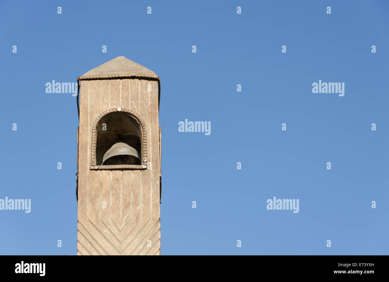 old wooden belfry toy model on blue sky background Stock Photo