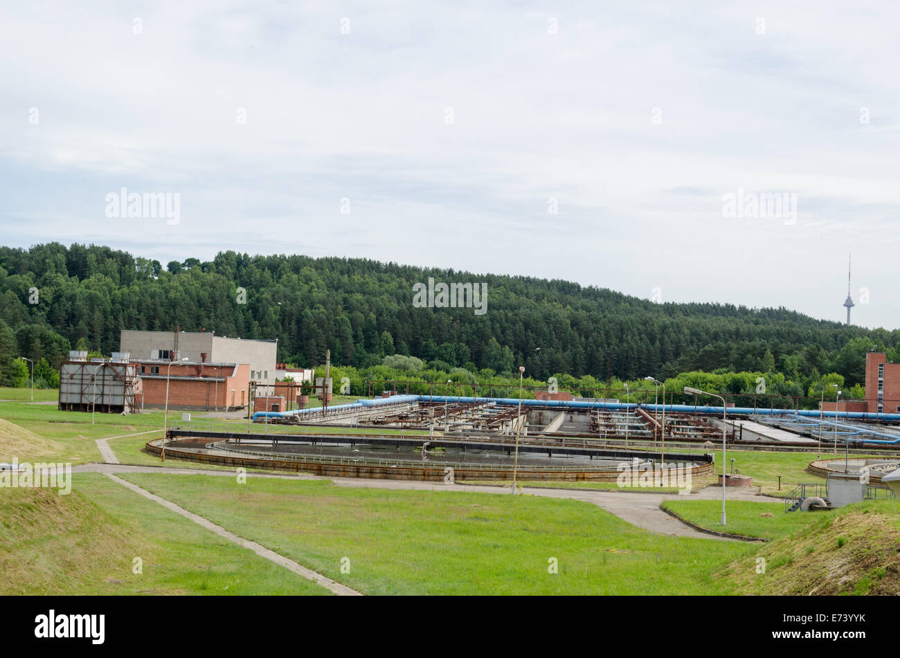 city sewage water treatment facility reservoir pools and equipment. Birds fly. Stock Photo
