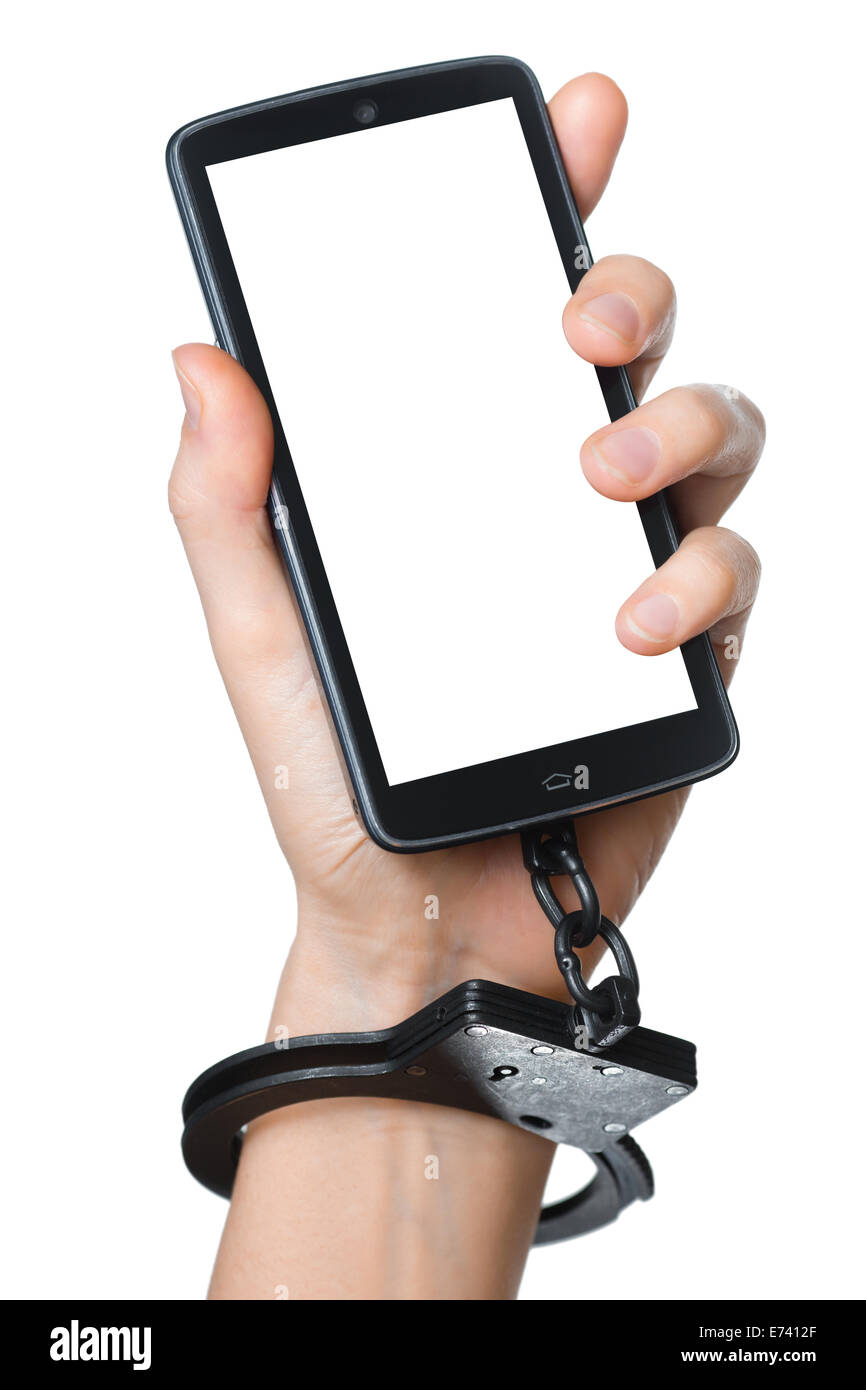 Mobile phone addiction concept. Smartphone with blank screen for your picture and handcuff in hand isolated on white. Stock Photo