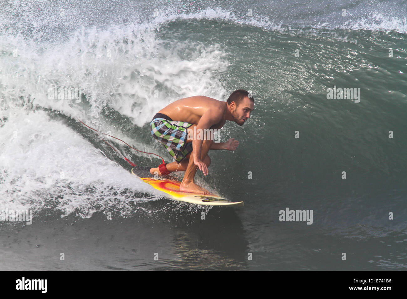 Surfing a wave Stock Photo - Alamy