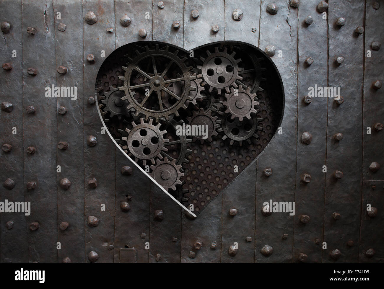 heart hole in old metal with gears and cogs Stock Photo