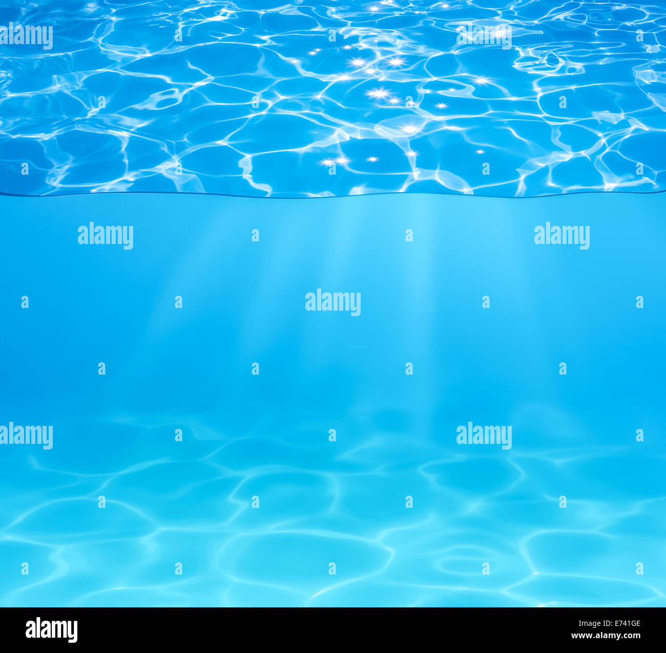 blue pool water surface and underwater with sun sparkles and beams Stock Photo