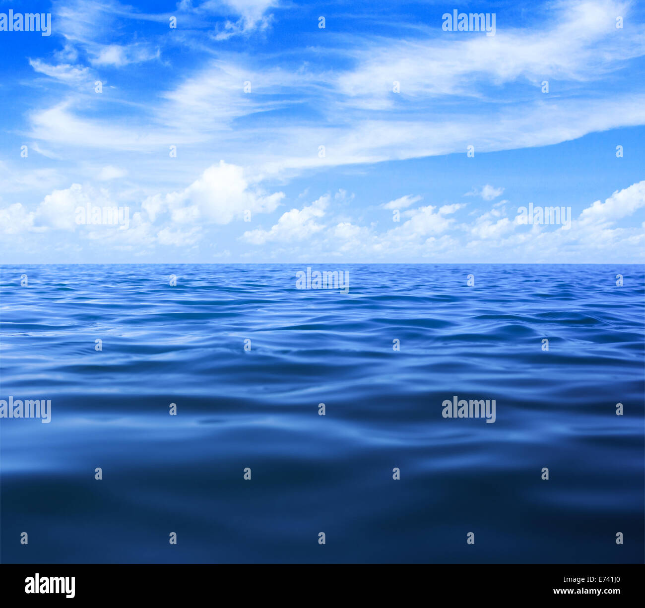 sea or ocean water surface with blue sky and clouds Stock Photo