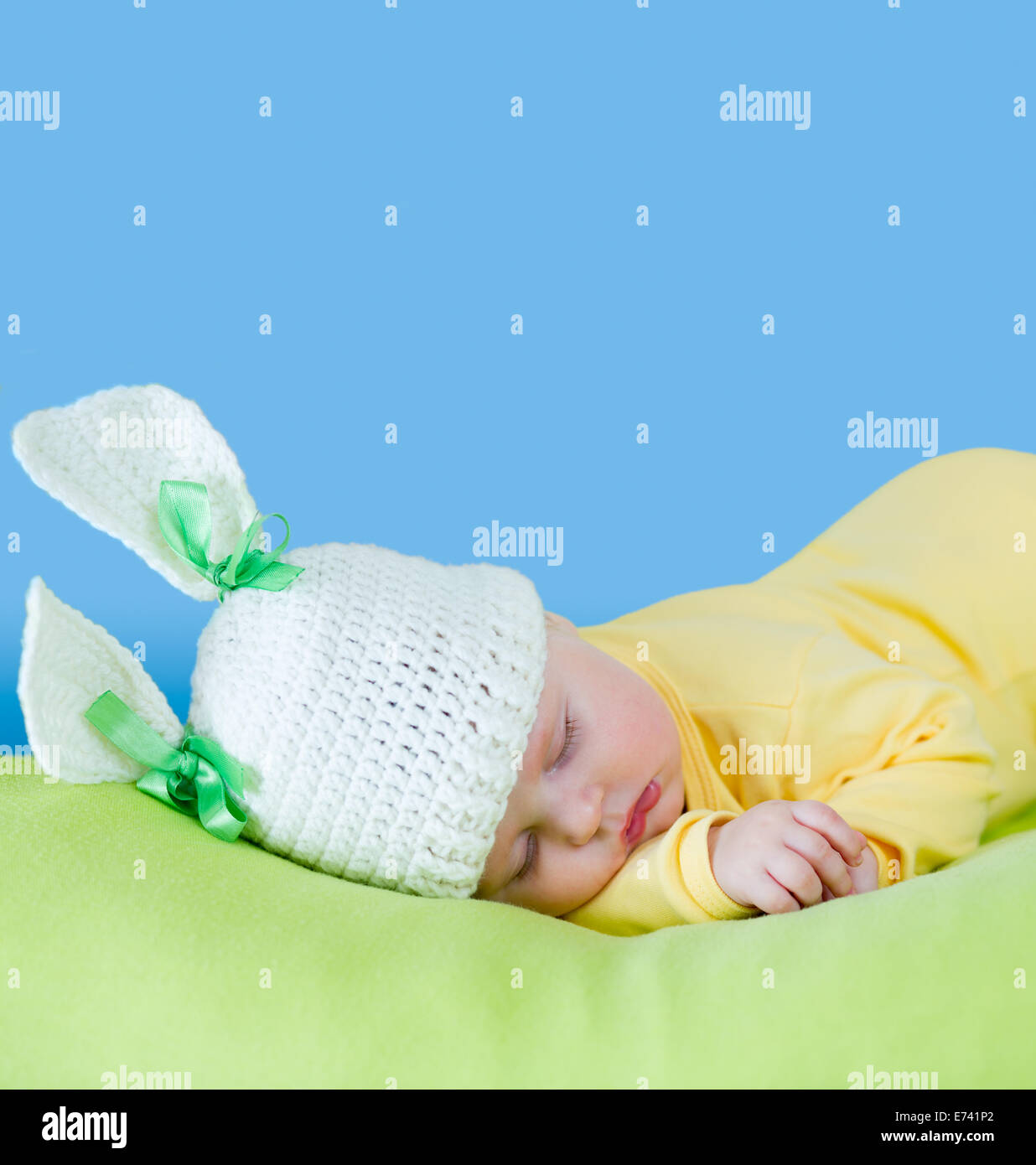sleeping baby closeup portrait in hare or rabbit hat with expandable blue copyspace Stock Photo