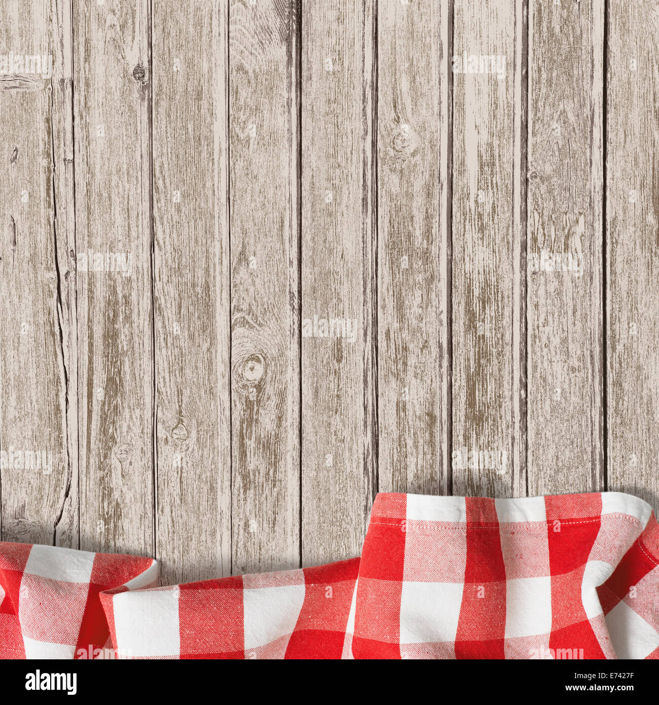 old wooden table with red picnic tablecloth background Stock Photo