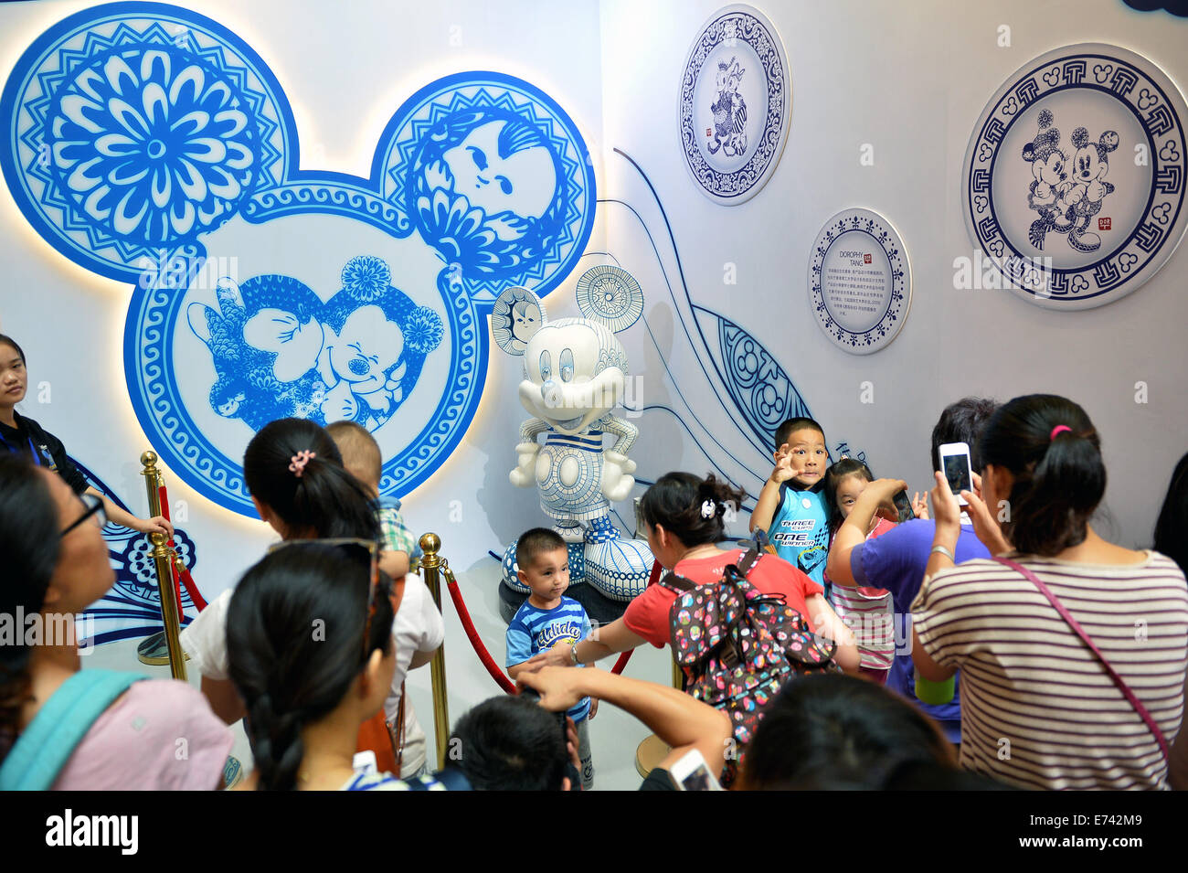 Beijing China 6th Sep 14 Children Pose For Photos With Disney Figure Mickey At The Walt Disney 90th Anniversary Exhibition In Indigo Department Store In Beijing Capital Of China Sept 6 14