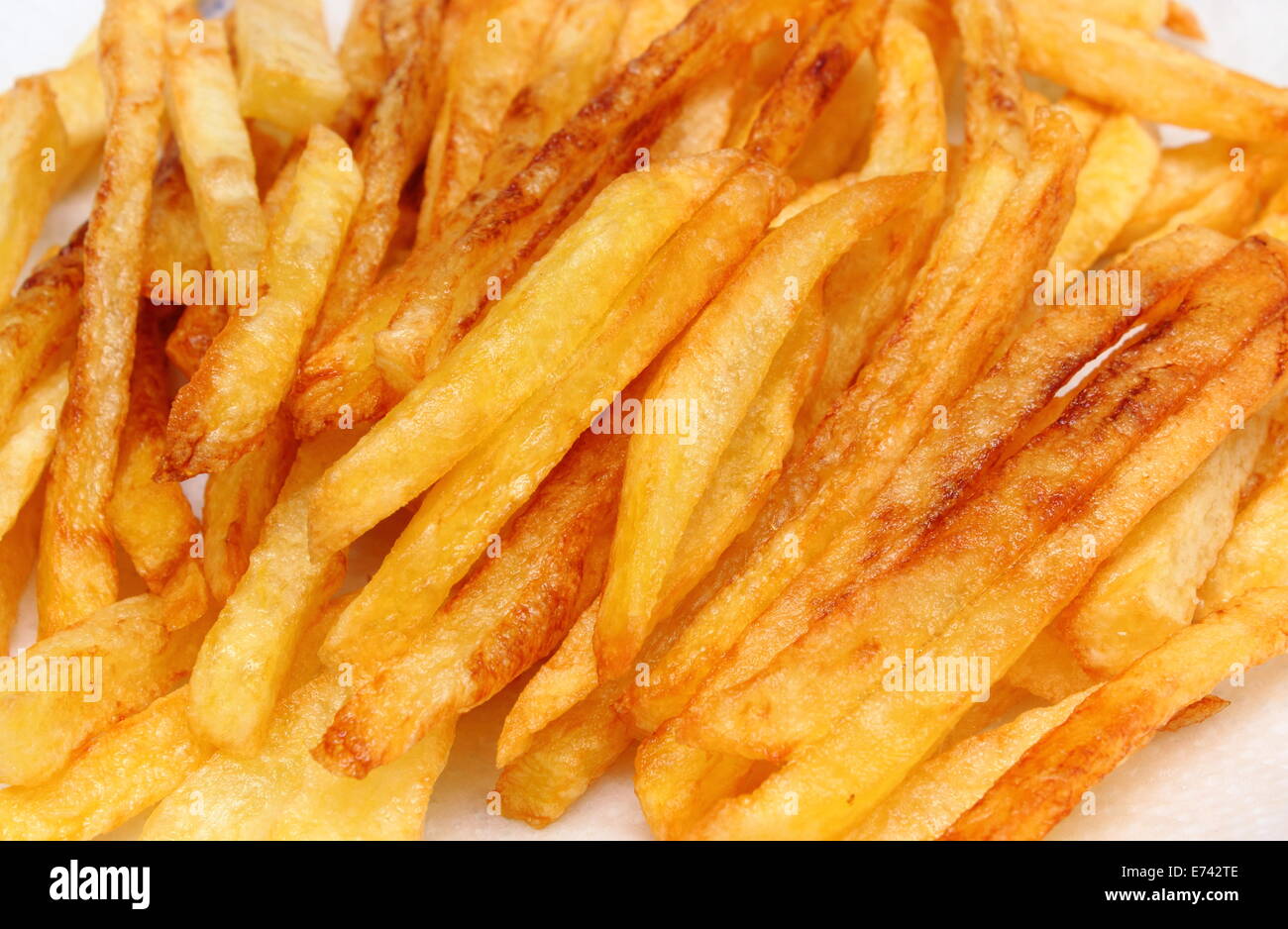 Heap of french fries fried in oil, deep fried, unhealthy and caloric