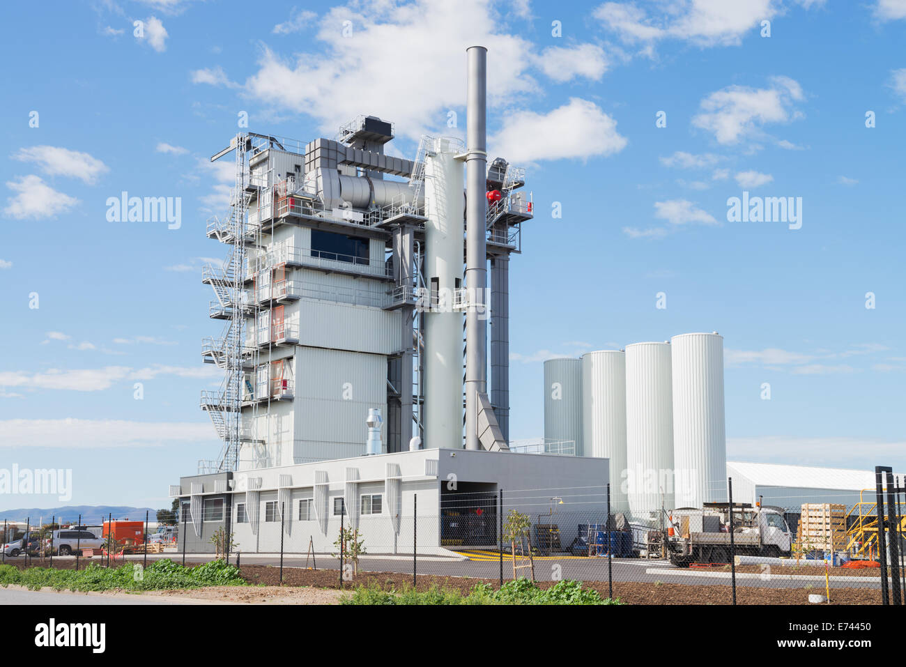 Modern industrial building of manufacturing plant against blue sky Stock Photo