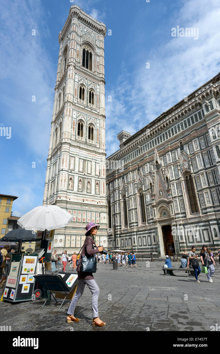 A tourist with camera near Giotto's Campanile in Florence Stock Photo