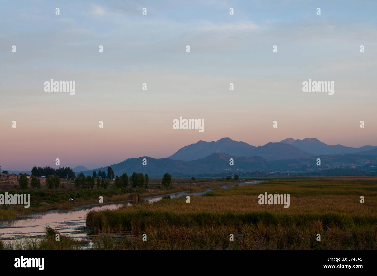 Sunset over the reed beds and mountains adjacent to Patzcuaro lake Stock Photo