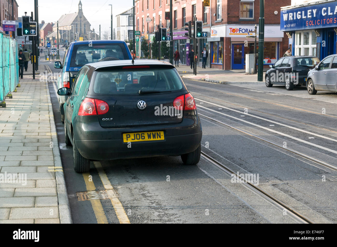 Two vehicles parked illegally and blocking the tram track, Union Street, Oldham, Greater Manchester, England, UK. Stock Photo