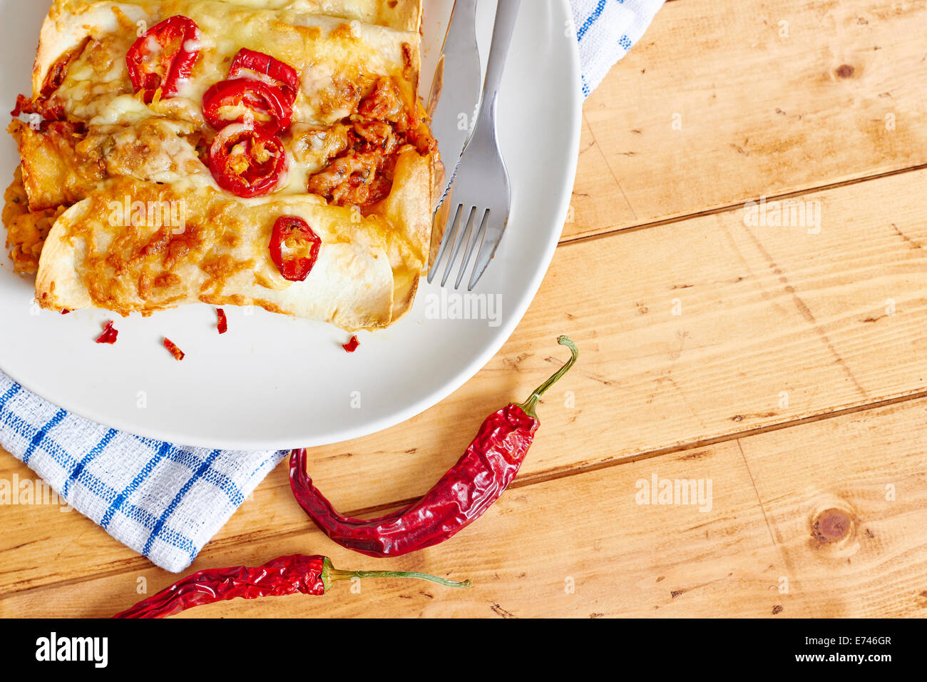Enchilada dish on wooden table Stock Photo