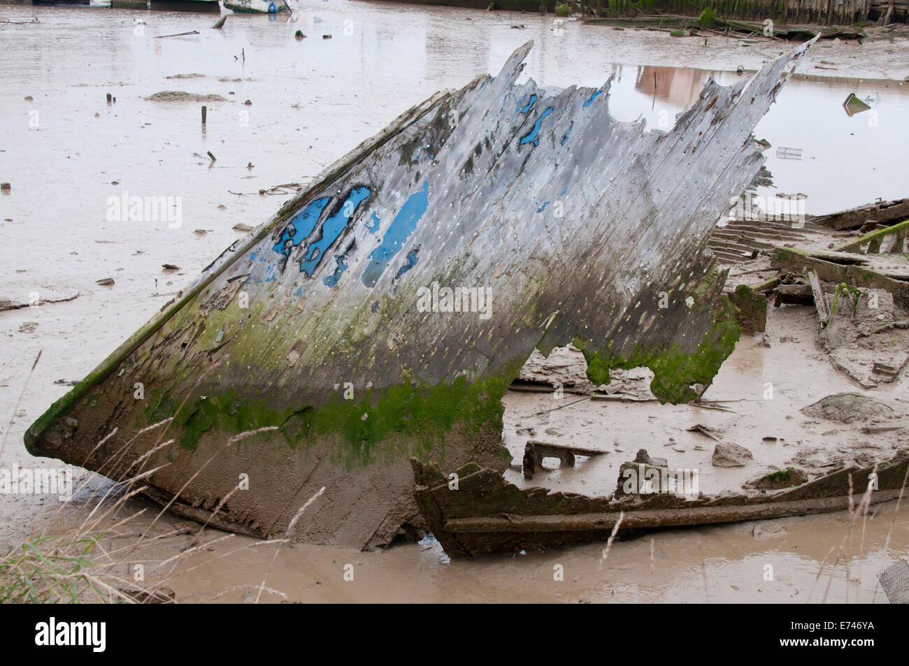 Shot of an old wooden boat, with peeling blue paint, that is decaying away Stock Photo