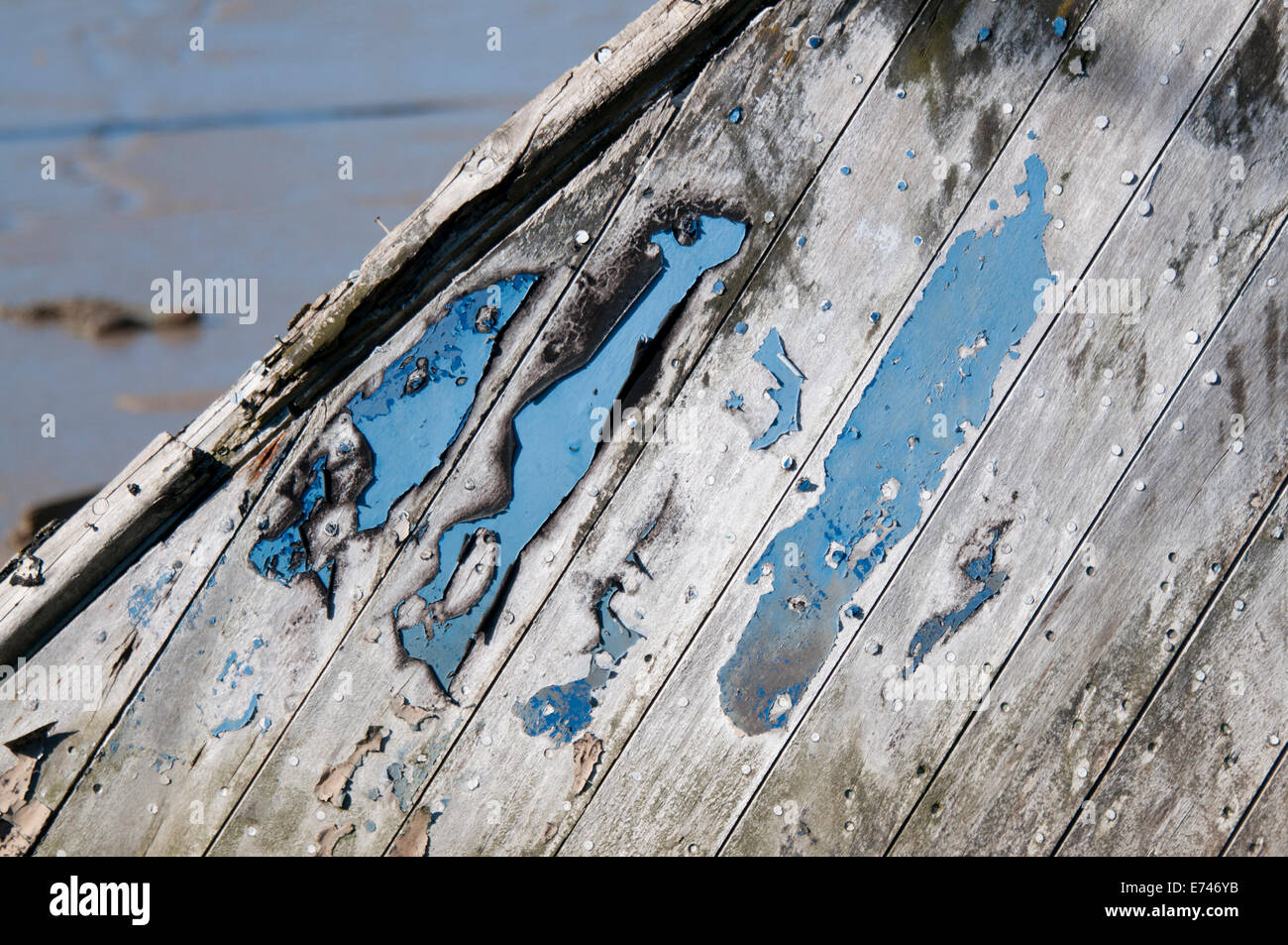 A close up shot of an old wooden boat with peeling blue paint Stock Photo