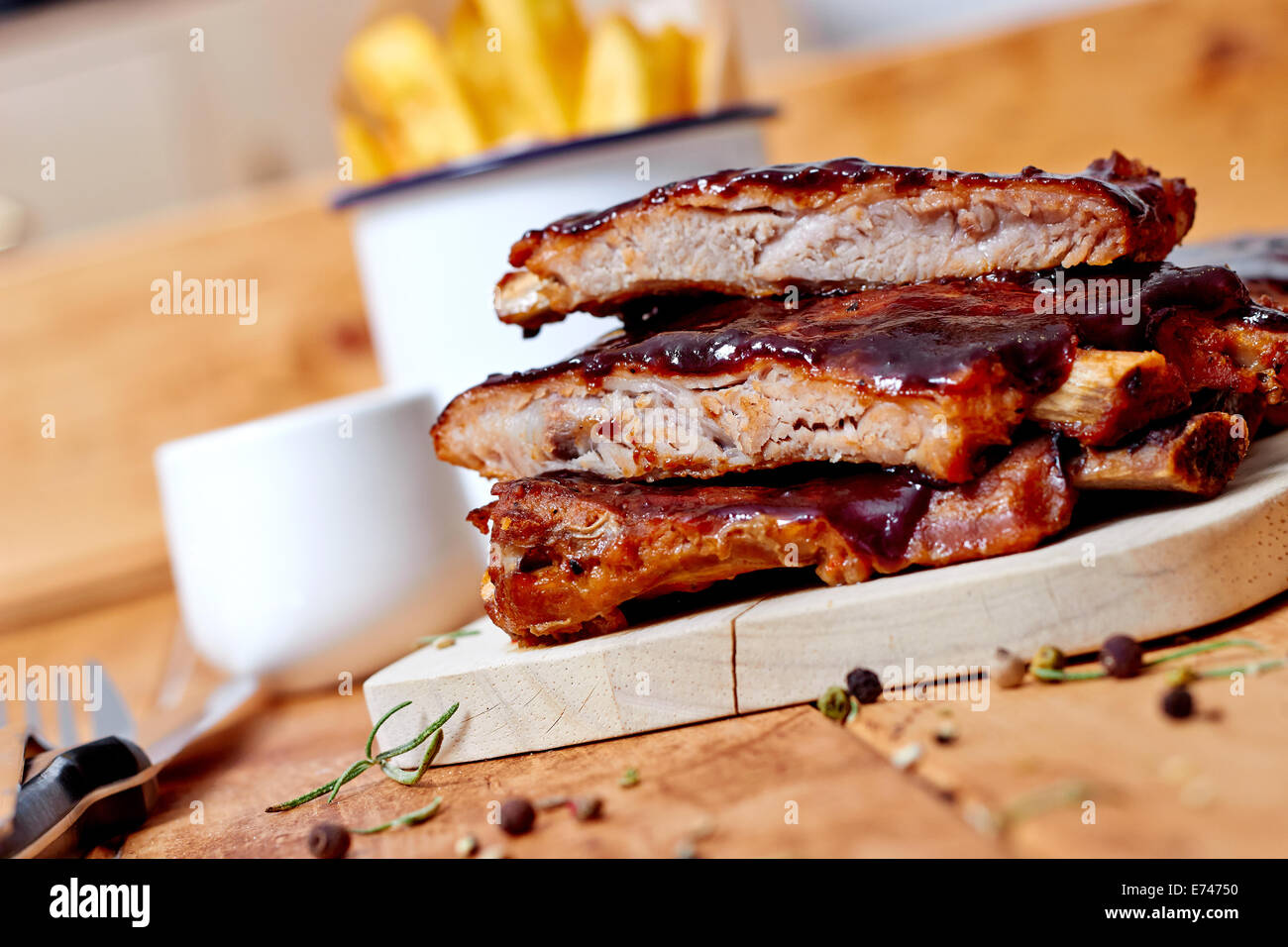 Barbecue ribs with sauce and fires on wooden table, rustic table Stock ...