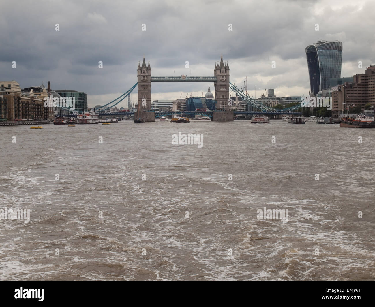 tower bridge and 20 fenchurch street and cuty hall viewed from the river thames under grey sky with storm clouds Stock Photo