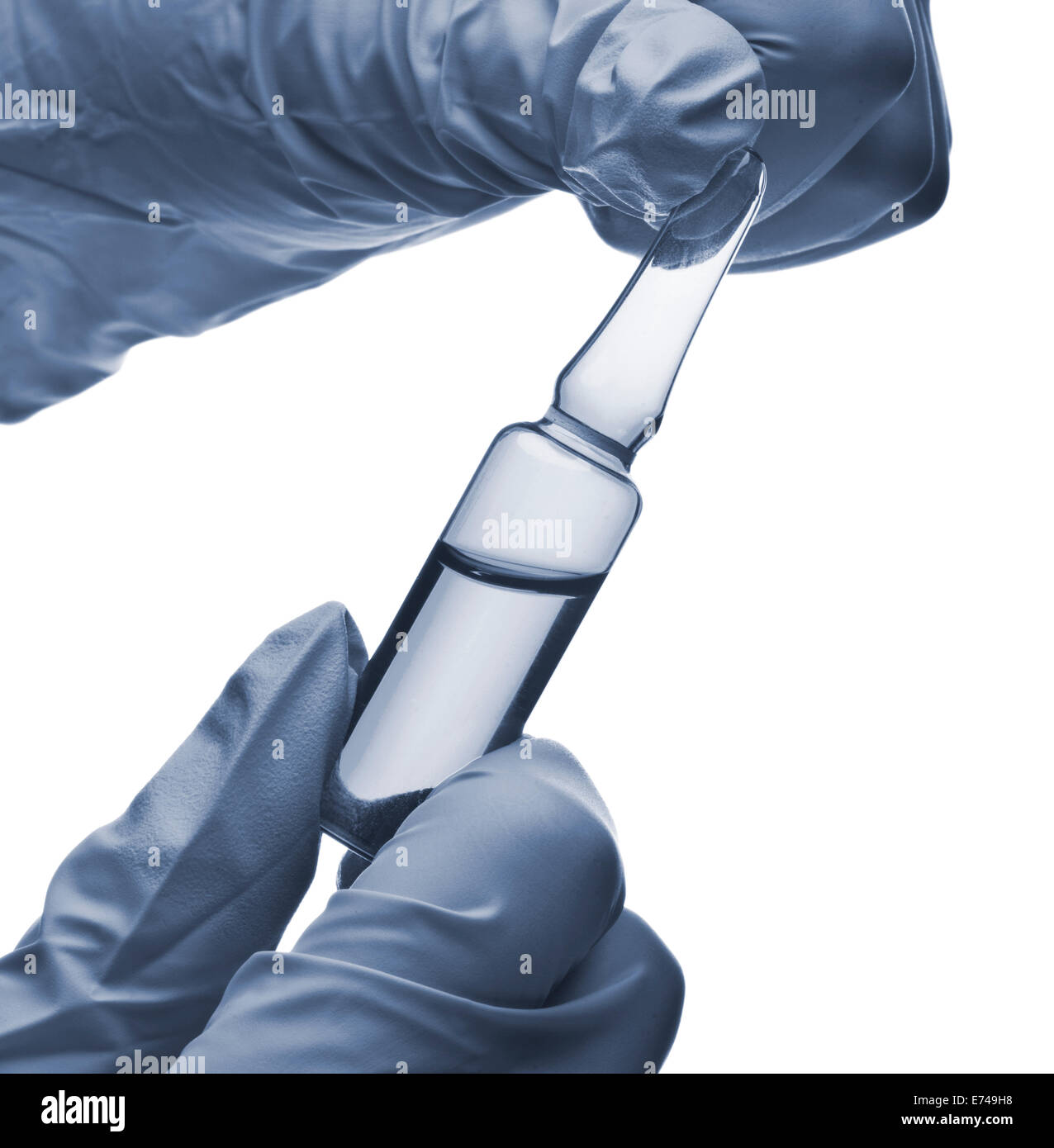 Hands with blue gloves holding an ampoule Stock Photo