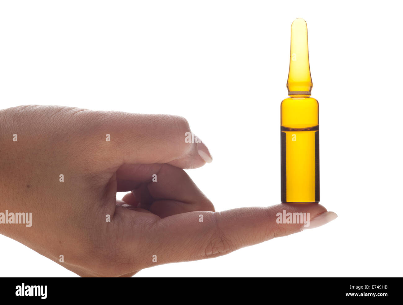 Hand holding an ampoule on a white background Stock Photo