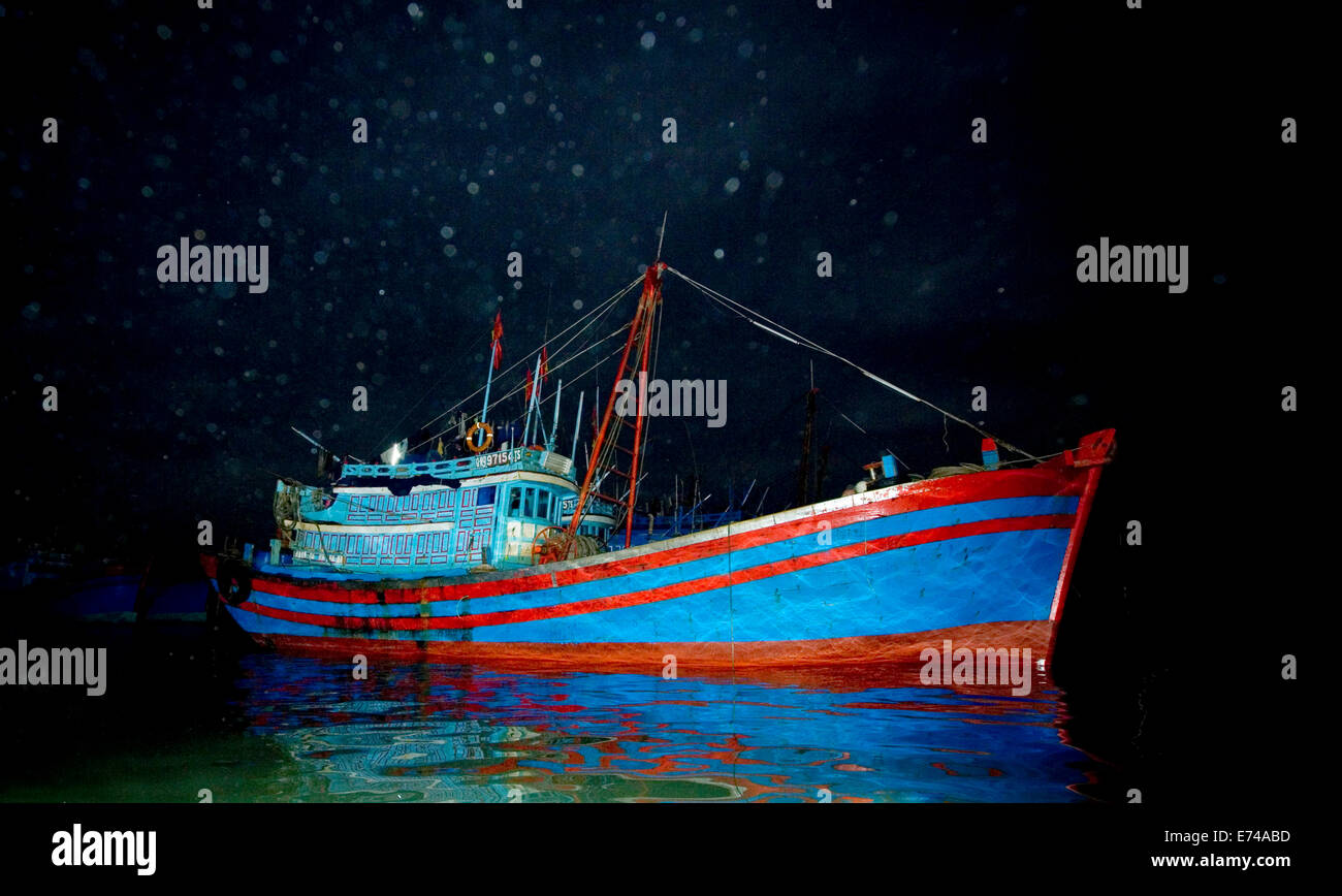 Wooden House boats or fishing boats in Halong Bay Vietnam at night and in darkness. Stock Photo