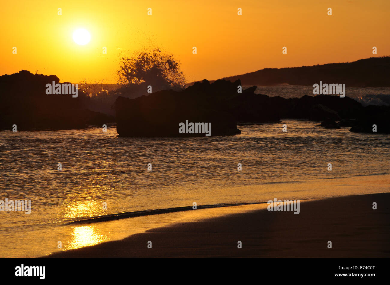 Hawaiian Beach Sunset with Wave in front of it. Stock Photo
