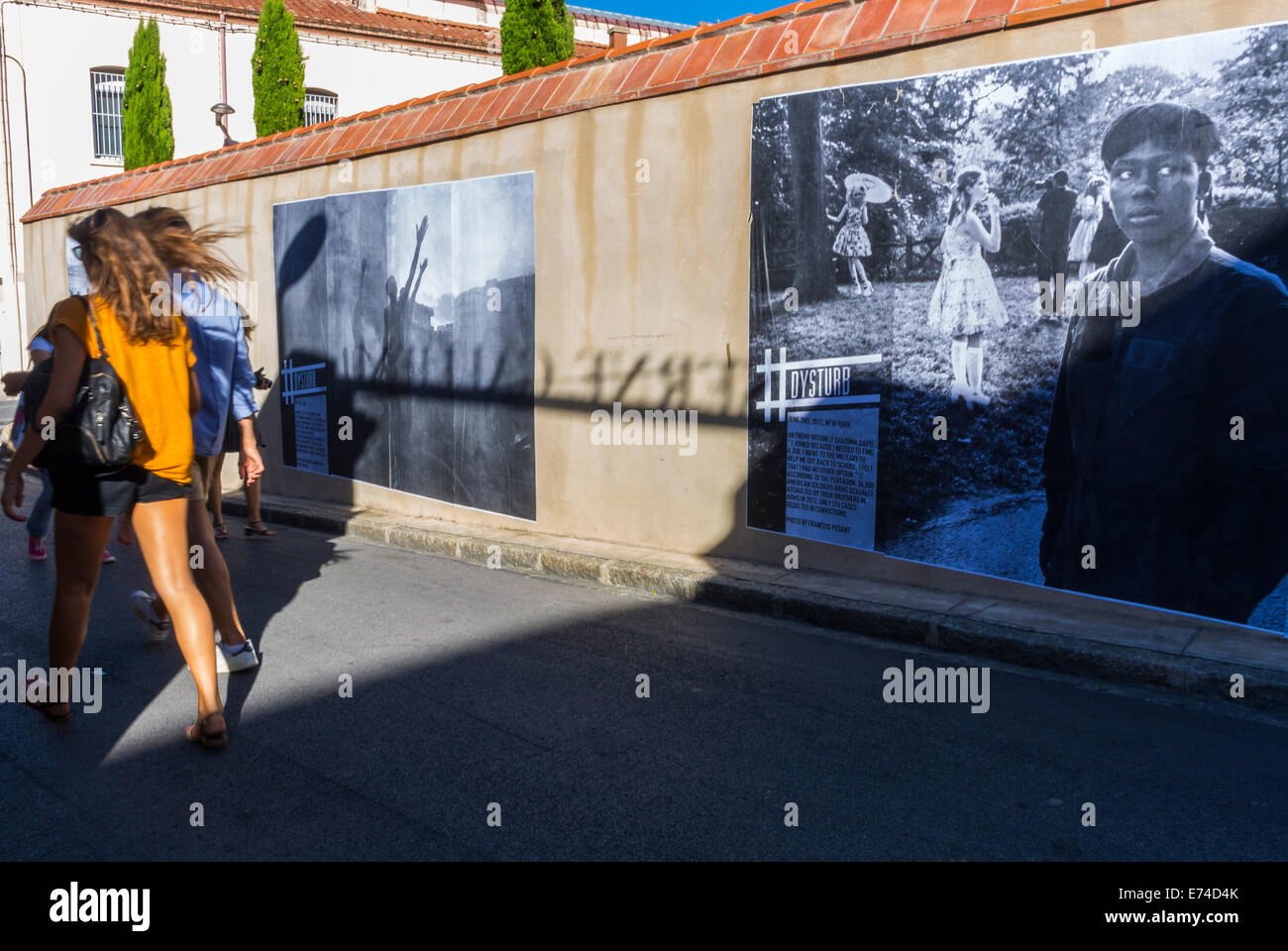 Perpignan, France, Tourists Visiting in 'Visa Pour l'Image' Photojournalism Festival Photography Gallery Exhibition, Outdoor on City Walls Stock Photo