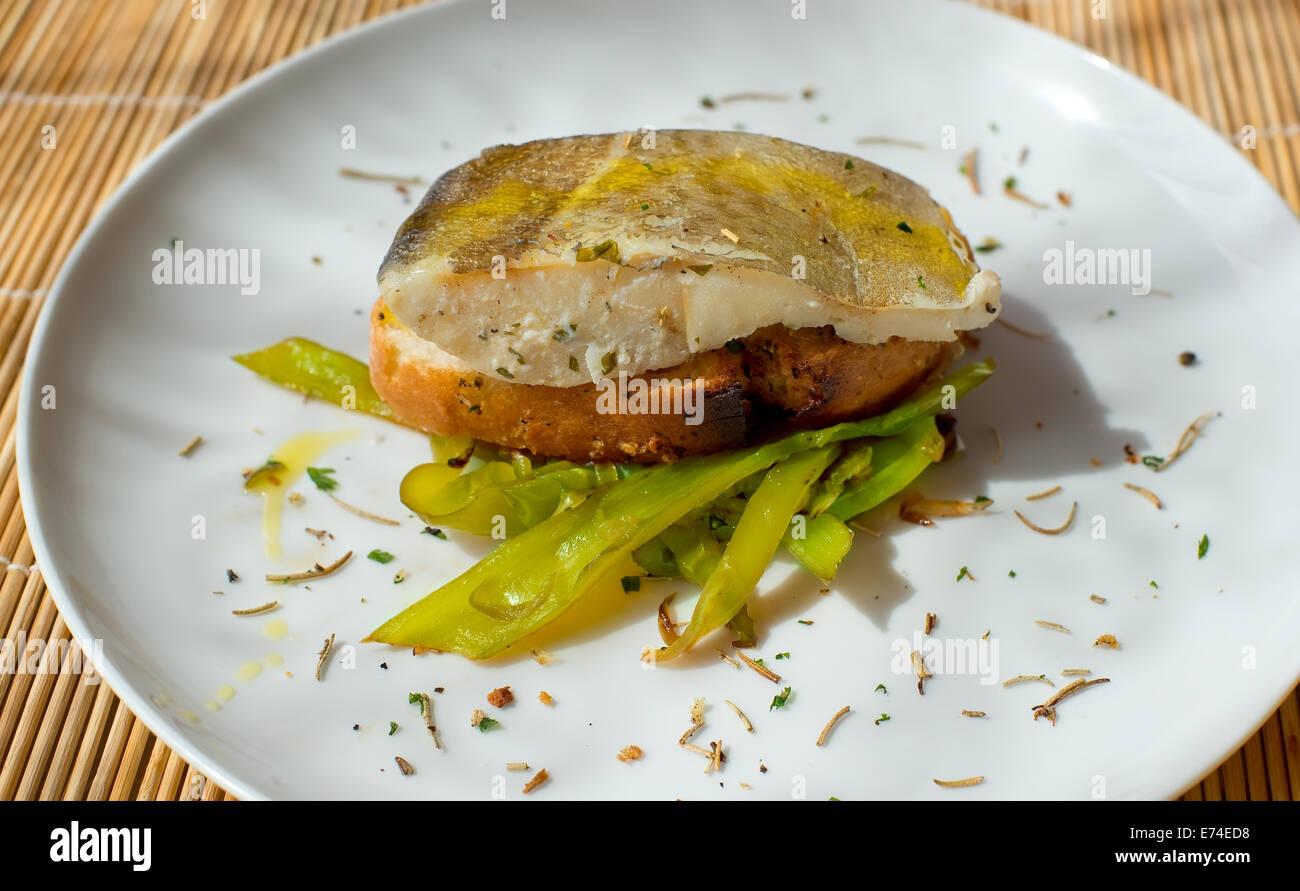 Typical spanish codfish pincho with green peppers. Stock Photo